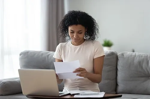 woman looking over financial documents